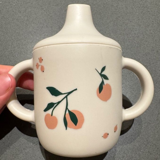 Liewood Baby Sippy Cup Beige with Orange Cherry Print - Image 1 of 3